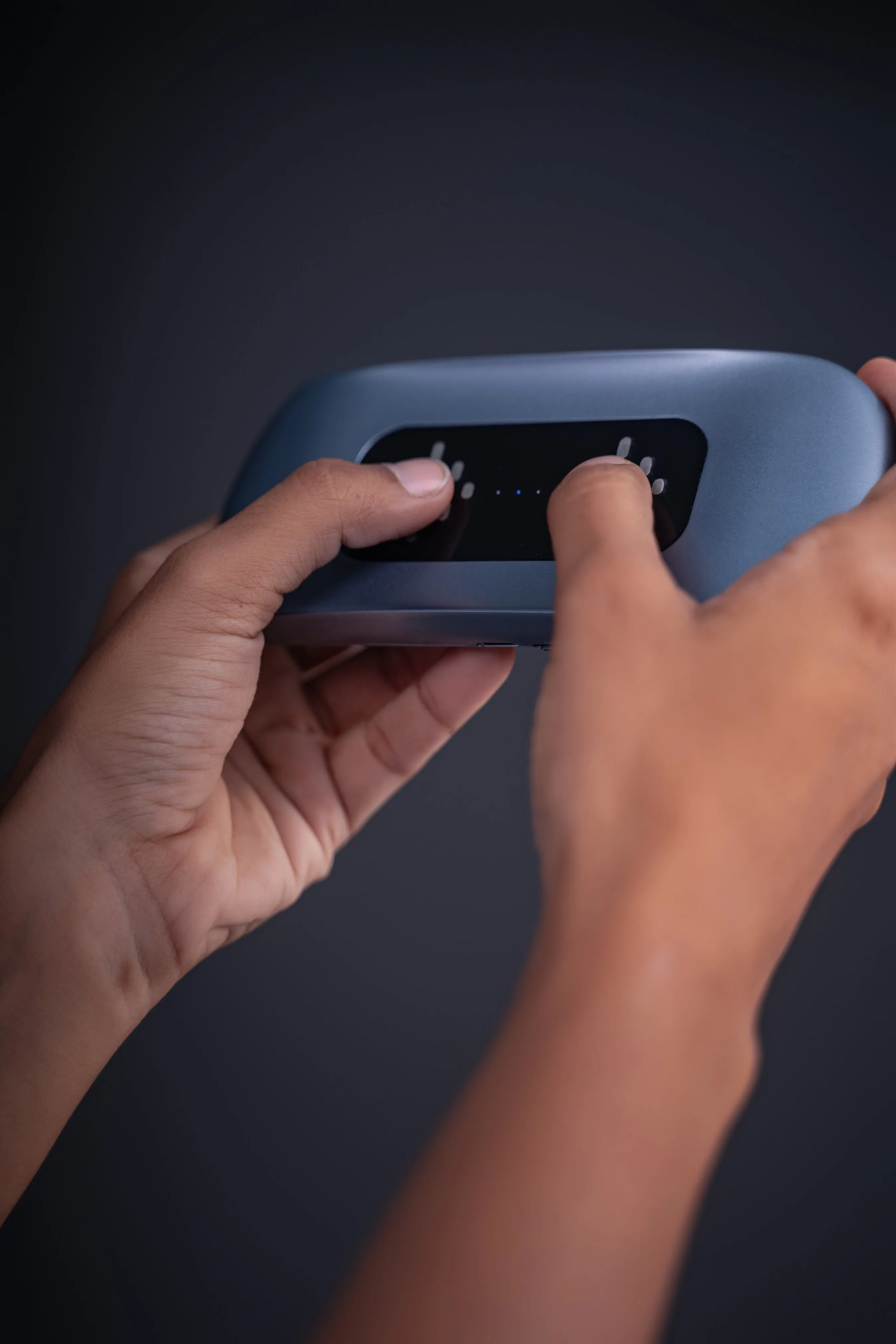 Two thumbs placed on the sensor pad of the EYVA Pro device.