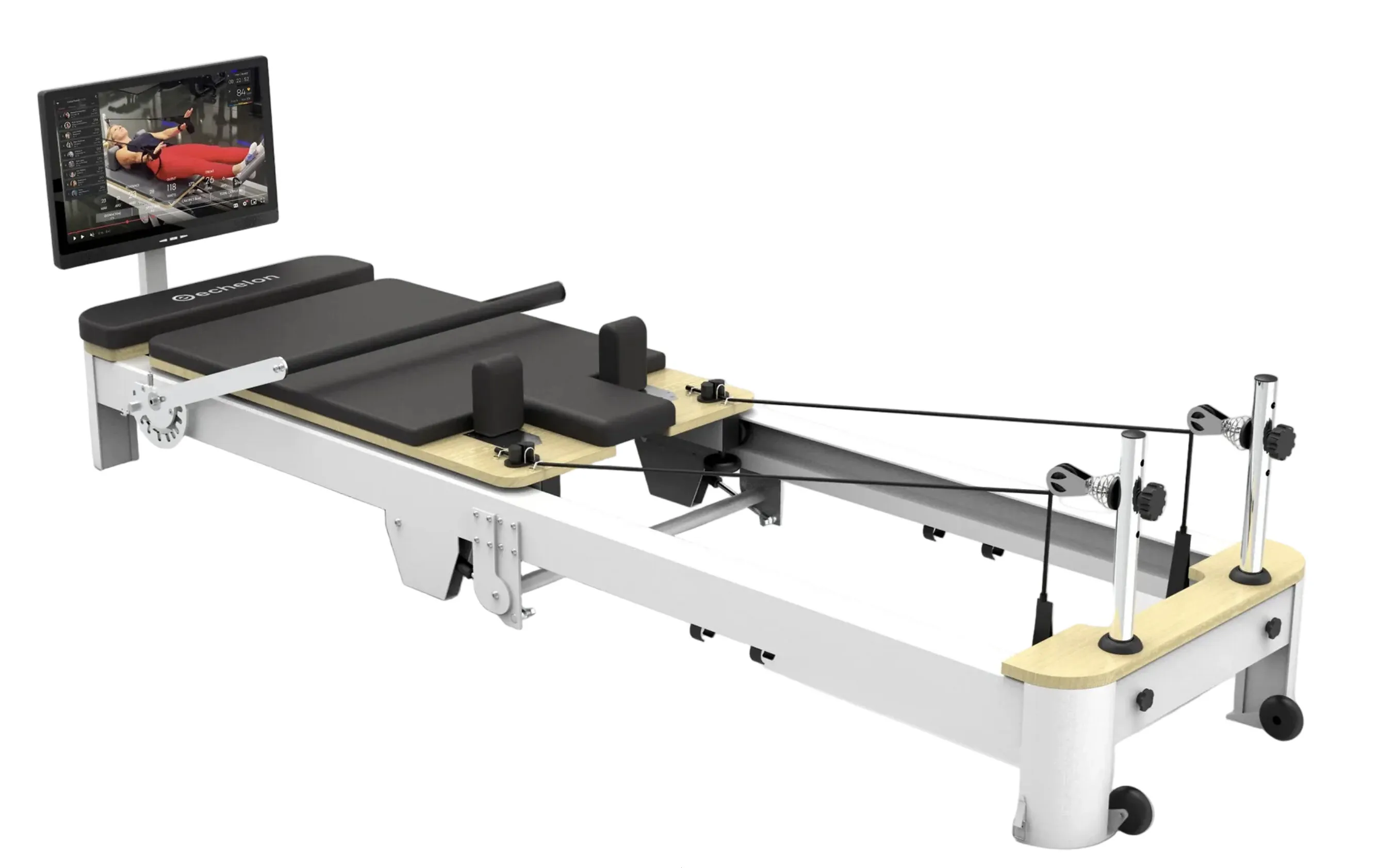 Pilates reformer machine with padded carriage, resistance cords and a monitor