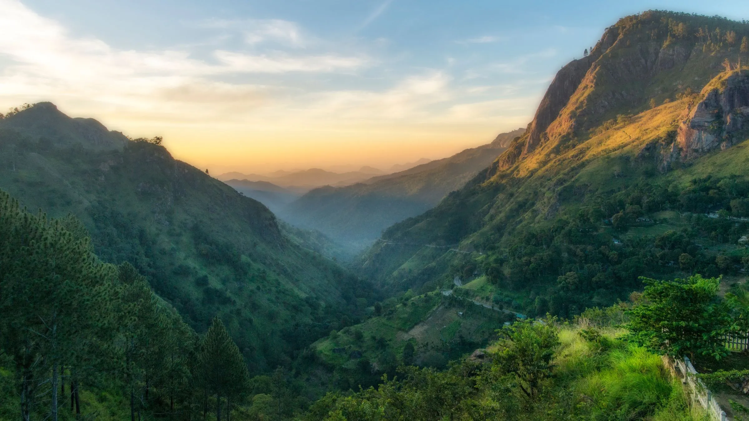 Sunrise over a green mountain valley.