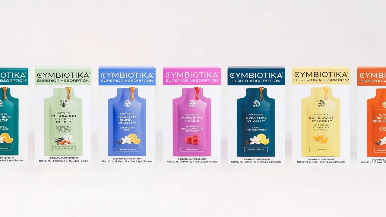 Seven colorful Cymbiotika supplement boxes lined up against a white background.